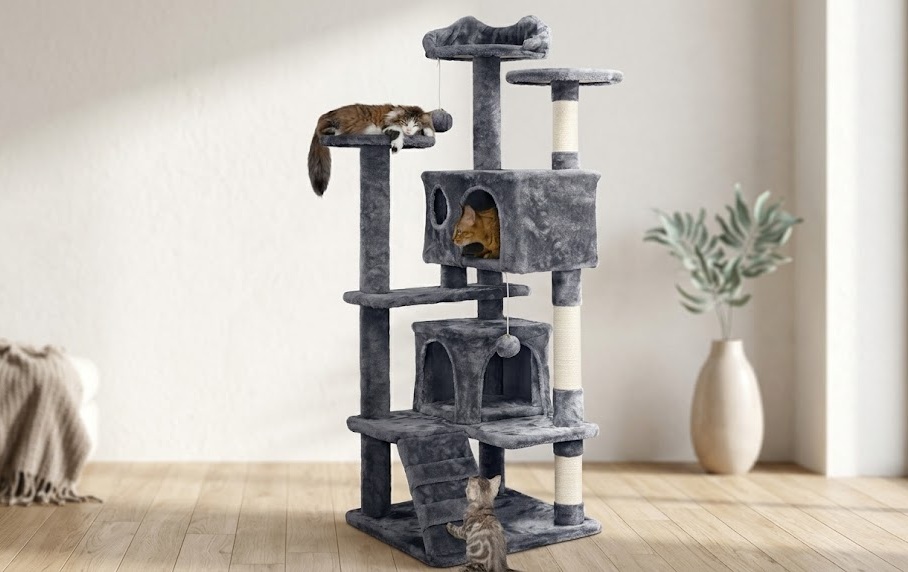 Yaheetech 138.5cm dark grey cat tree tower with two condos, sisal scratching posts and corrugated ramp, with three cats resting and exploring across multiple levels in a bright modern living room